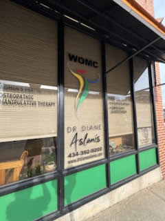 Window signage displaying Dr. Diane Aslanis’ name and practice contact information