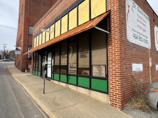 Sidewalk view looking toward the entrance of Aslan Acupuncture building